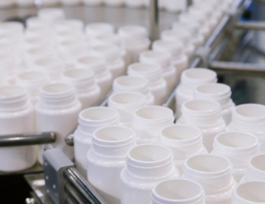 white-plastic-bottle-on-the-production-line-of-the-conveyor-at-filling-machine-in-the-factory